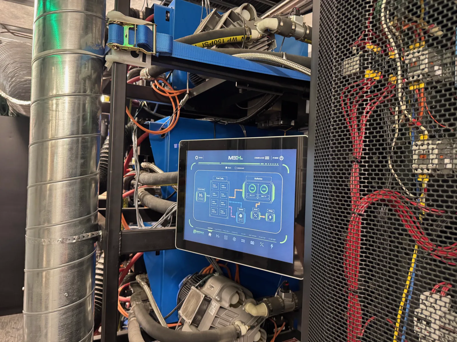Control touchscreen showing a system diagram, mounted inside an equipment rack